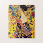 Puzzle Dame Gustav Klimt avec ventilateur<br><div class="desc">Puzzle représentant la peinture à l’huile de Gustav Klimt Lady with Fan (1918). Une femme portant un kimono bleu tient un ventilateur rouge contre un arrière - plan jaune coloré de fleurs et de paons. Un grand cadeau pour les amateurs de Japonisme et d'art européen.</div>