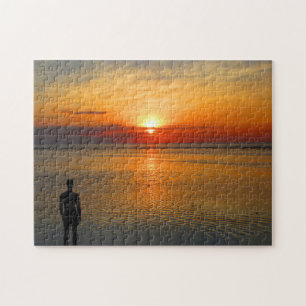Puzzle homme au coucher de soleil sur la plage