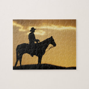 Puzzle Silhouette de cowboy à cheval au coucher du soleil