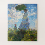 Puzzle Une femme avec un parasol par Claude Monet<br><div class="desc">A son plus pur, l'impressionnisme était à l'écoute de la peinture paysagère, un sujet que Monet privilégiait. Dans Femme avec un parasol - Madame Monet et Son Fils, son talent de peintre artistique est tout aussi évident. L'artiste avait l'intention de transmettre le sentiment d'une sortie familiale décontractée plutôt qu'un portrait...</div>