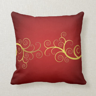Remous d'or sur le coussin élégant rouge
