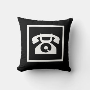 rétro téléphone blanc sur coussin noir