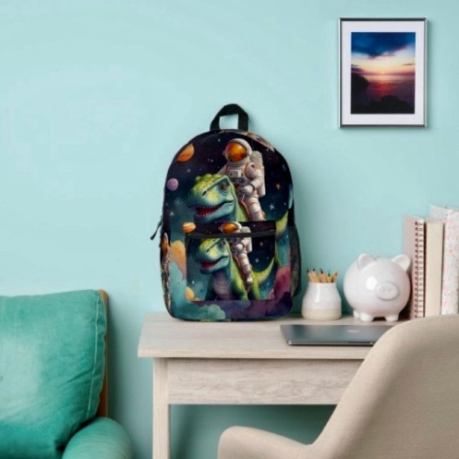 Sac À Dos Imprimé Astronaute sur Dino dans l'espace  (Backpack – D: 17"x12.5"x5" Two-chamber design with laptop storage pouch. Mesh side pocket.
 
)