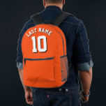 Sac À Dos Imprimé Custom Orange White Nom Sports Jersey Numéro<br><div class="desc">Sac à dos jersey sport conçu sur mesure en orange vif avec lettrage blanc frappant et ombre noire en gras pour votre nom de famille et le numéro choisi. Ce sac à dos personnalisé est un incontournable pour les amateurs de sport, ajoutant une touche d'individualité à votre collection d'équipement. Conçu...</div>