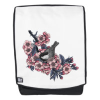 Poulet sur une branche de cerise en fleurs