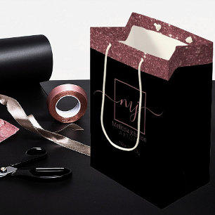 Sac cadeau moyen or rose élégant sur fond noir