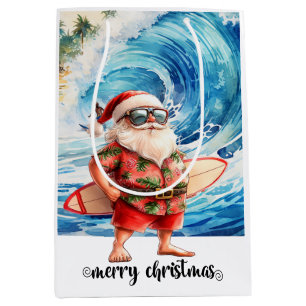 Sac Cadeau Moyen Père Noël surfeur avec sa planche de surf sur la p