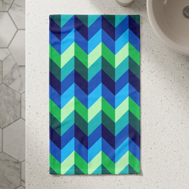 Serviette à main à chevrons ombrés bleu-vert (Top down view of Blue Green Ombre Chevrons Hand Towel on a counter in a modern style bathroom.)