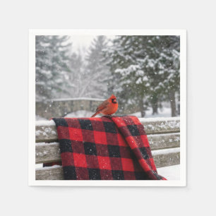 Serviette En Papier Cardinal sur une couverture à carreaux enneigée