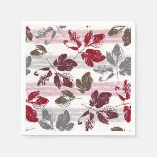 Serviette En Papier Feuilles multicolores sur un fond rayé.