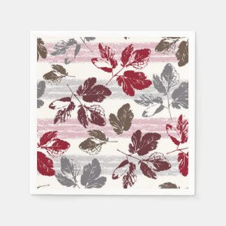 Serviette En Papier Feuilles multicolores sur un fond rayé.