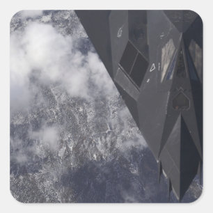 Sticker Carré Un F-117A Nighthawk survole la montagne