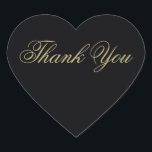 Sticker Cœur Élégant Merci de Monogramme Noir et Or<br><div class="desc">Ces stickers de remerciement élégants en forme de coeur en or sur le noir seront la touche parfaite à vos cartes de remerciement. Une partie de notre Elégante suite de faire-part de mariage Black & Gold Heart Flourish conçue par l'artiste Susan Coffey.</div>
