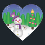 Sticker Cœur Hippie Christmas Snowman<br><div class="desc">Mignonne hippie bonhomme de neige portant un casquette violet, écharpe et lunettes de soleil avec des boutons de fleurs de signe de paix et une fleur de visage souriant sur son casquette. Derrière le bonhomme de neige se trouve une scène hivernale avec des arbres de Noël, de la neige et...</div>