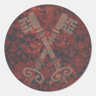 Sticker Rond 21èmes clés médiévales contre le marbre rouge