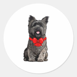 Sticker Rond Cairn Terrier portant une carte de voeux de Noël