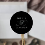 Sticker Rond Calligraphie romantique Enveloppe Mariage noir sce<br><div class="desc">Ces calligraphie romantique enveloppes de mariage noir sont parfaites pour un simple mariage. Le design classique moderne comprend des tourbillons fantaisistes et des fleurs fantaisistes avec une magnifique typographie élégante et lettrée à la main. Personnalisez le étiquette avec les noms de la mariée et du marié.</div>