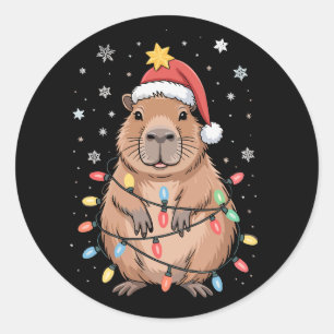 Sticker Rond Capybara de Noël avec chapeau de Père Noël lumière