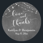Sticker Rond Chalkboard Lights Mariage Script Love and Thanks<br><div class="desc">Avec un arrière - plan de tableau noir texturé et deux cordes d'accents lumineux blanc scintillants, j'ai combiné une police de script élaborée et moderne pour rendre des graphiques représentant des mots clés et des phrases dans cette collection sur le thème du mariage. Dans cet autocollant, la calligraphie dit "amour...</div>