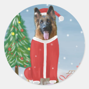Sticker Rond Chien berger allemand en neige avec cadeaux de Noë