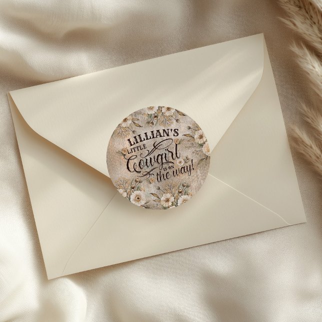 Sticker Rond Cowgirl Boho Floral Western Script (A Cowgirl is on the Way Sticker with western script typography and boho floral elements)