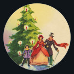 Sticker Rond Dickens style Christmas Illustration<br><div class="desc">Old English Dickens style Christmas Illustratation with a familiy standing in the snow in front of a Christmas tree with bright burning candles.</div>