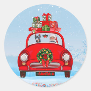 Sticker Rond Doberman dans une voiture avec le Père Noël