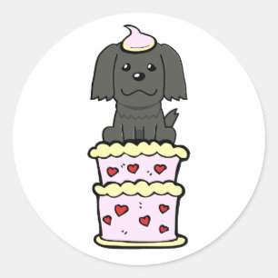 Sticker Rond Drôle chien noir sautant d'un gâteau