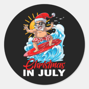 Sticker Rond Drôle de Noël en juillet Santa surfant sur la plag