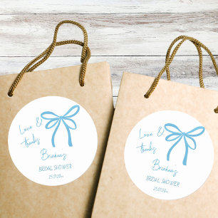 Sticker Rond Elle noue la faveur de l'arc en ruban bleu noeud