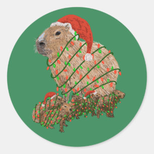 Sticker Rond Famille de Capybaras de Noël enveloppée de lumière