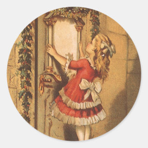 Sticker Rond Fille victorienne de Noël vintage accrochant une g