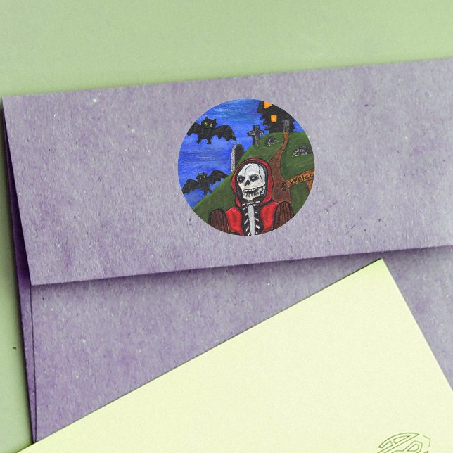 Sticker Rond Grim Reaper Skeleton Bats Cimetière (Skeleton in red hooded cape haunted house on hill bats tombstones on Halloween round stickers.)