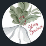 Sticker Rond Joyeux Noël aquarelle Noël feuillage de Noël<br><div class="desc">Aquarelle peinture à la main faite avec grand soin pour cet autocollant de Noël aquarelle. Le feuillage, les branches et les fruits ont été inspirés par les souvenirs de Noël traditionnels, avec une riche palette de tons verts, rouges et neutres... et parés d'un bel arc. Terminé avec une élégante et...</div>