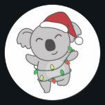 Sticker Rond Koala Christmas Winter Animals Koalas Classic Roun<br><div class="desc">The koala at Christmas with fairy lights. Funny animals with gifts and snow for the holidays. A sweet Christmas greeting. Koalas are cute animals and perfect for Christmas.</div>