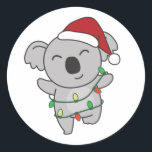 Sticker Rond Koala Christmas Winter Animals Koalas Classic Roun<br><div class="desc">The koala at Christmas with fairy lights. Funny animals with gifts and snow for the holidays. A sweet Christmas greeting. Koalas are cute animals and perfect for Christmas.</div>