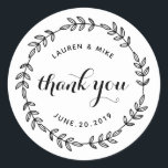 Sticker Rond Laurel Wreath Wedding Favor Merci<br><div class="desc">Conçu sur mesure pour un mariage rond, merci les autocollants/étiquettes avec une couronne botanique rustique dessinée à la main. Personnalisez avec le nom du couple/épouse et du marié et la date du mariage. Ces autocollants élégants et fantaisistes sont parfaits pour ajouter une touche de style aux enveloppes mariages, aux cartes,...</div>