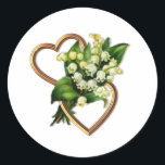 Sticker Rond Lily de la Vallée avec deux Coeurs Romantique<br><div class="desc">Cet autocollant a beau lis de la vallée spray avec deux coeurs en or ouvert. Les coeurs sont enchevêtrés horizontalement. Les fleurs blanches ressemblent à des tiges qui traversent le centre du coeur, Plus d'objets avec ce design sont disponibles dans la collection "Lily of the Valley and Two Hearts" de...</div>
