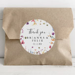 Sticker Rond Merci floral sauvage coloré Favoriser mariage<br><div class="desc">Ce sticker floral sauvage coloré merci mariage faveur classique rond collant est parfait pour un mariage rustique. Le design présente des fleurs sauvages jaunes, violettes et blanches avec du feuillage dans un arrière - plan rose et vert aquarelle. Faites de l'autocollant votre propre étiquette en incluant vos noms, l'événement (s'il...</div>
