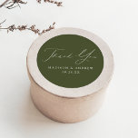 Sticker Rond Merci Mariage Olive Green moderne<br><div class="desc">Élégant autocollant de mariage affichant "Merci" dans un magnifique script de calligraphie blanche avec un arrière - plan vert olive ou couleur de votre choix. Personnalisez les autocollants de remerciement modernes avec vos noms et date mariage. Les autocollants de remerciement vert olive sont parfaits pour sceller les enveloppes de carte...</div>