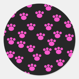 Sticker Rond Motif Empreinte de patte rose et noir.