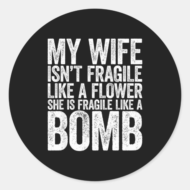 Sticker Rond My Wife Isn't Fragile Like A Flower She Is Like A  (Devant)