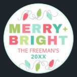 Sticker Rond Pastel Christmas Lights Joyeux Nom de famille<br><div class="desc">Répandez la fête avec nos stickers 'Joyeux Lumineux' Noël ! Avec un design charmant de lumières de Noël pastel et un message festif "Joyeux Lumineux", ces autocollants ajoutent une touche de fantaisie et de personnalisation à vos cadeaux. Customisez l'autocollant avec votre nom de famille et votre année pour une touche...</div>