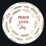 Sticker Rond Peace Love Joy Simple Rustic Christmas Foliage<br><div class="desc">Parfaits pour l'emballage cadeau ou les scellés d'enveloppe, ces autocollants ont un design rustique simple du feuillage de Noël. Le texte du centre dit "Peace love and Joy" et est encadré de cercles de pins, de branches de sapins, d'ornements de Noël, de saints, de mistletoe et de baies d'hiver. Des...</div>
