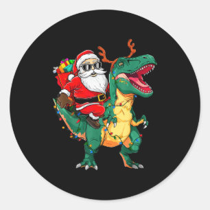 Sticker Rond Père Noël à cheval sur un dinosaure T Rex Noël drô