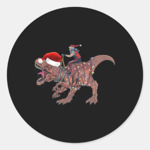 Sticker Rond Père Noël à cheval sur un dinosaure T Rex Noël Gar