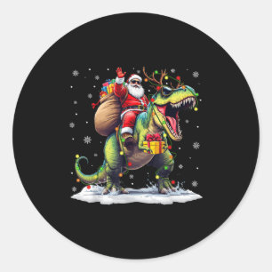 Sticker Rond Père Noël à cheval sur un dinosaure T Rex Noël Gar