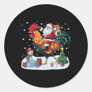 Sticker Rond Père Noël à cheval sur un poulet drôles de lumière