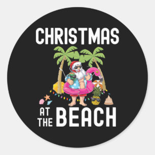 Sticker Rond Père Noël au palmier surfant Noël d'été sur la pla