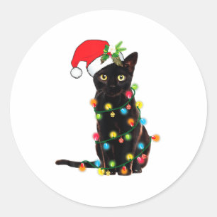 Sticker Rond Père Noël chat noir empêtré dans les lumières de N